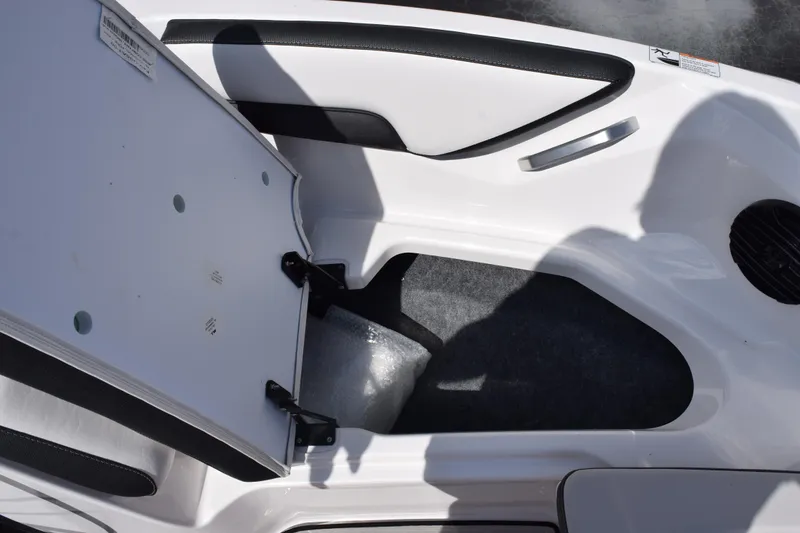 Slide: The Image of Open storage compartment in 2026 Yamaha Boats 195S, featuring sleek white and black interior design. - 19