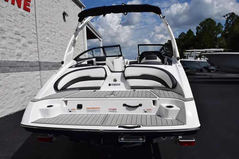 Slide: The Image of 2026 Yamaha Boats 195S, rear view, sleek design, white and black seating, outdoor setting. - 5