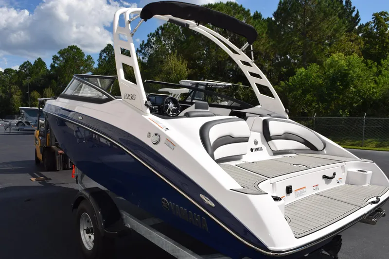 Slide: The Image of 2026 Yamaha Boats 195S, sleek design, blue and white, parked outdoors. - 6