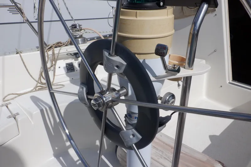 Slide: The Image of Steering wheel of a 2002 Seaward Eagle 32 RK sailboat, featuring nautical controls. - 13