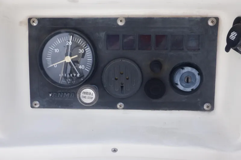 Slide: The Image of Instrument panel of a 2002 Seaward Eagle 32 RK boat with RPM gauge and controls. - 14