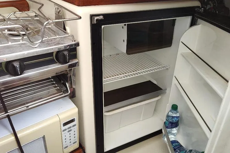 Slide: The Image of Compact kitchen in 2002 Seaward Eagle 32 RK with fridge, stove, and microwave. - 31
