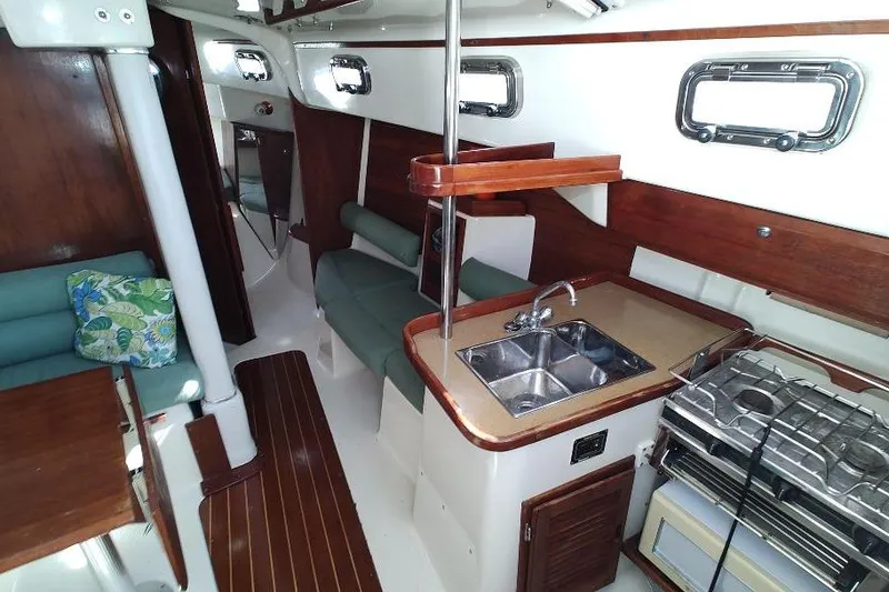 Slide: The Image of Interior of 2002 Seaward Eagle 32 RK sailboat with kitchen and seating area. - 32