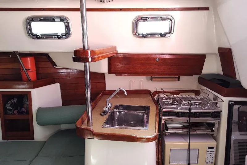 Slide: The Image of 2002 Seaward Eagle 32 RK yacht interior with kitchenette, sink, stove, and microwave. - 34