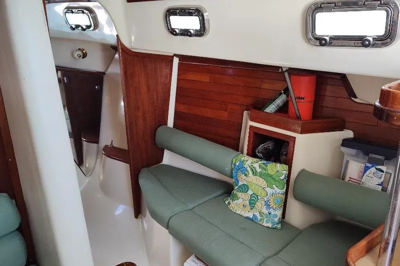 Slide: The Image of Interior of 2002 Seaward Eagle 32 RK sailboat with wooden paneling and green seating. - 36
