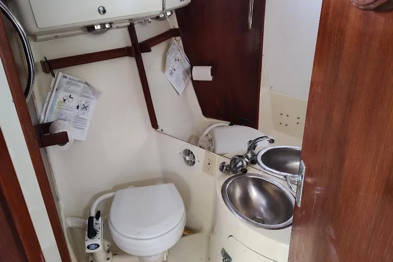 Slide: The Image of Compact bathroom in 2002 Seaward Eagle 32 RK sailboat, featuring toilet and sink. - 37