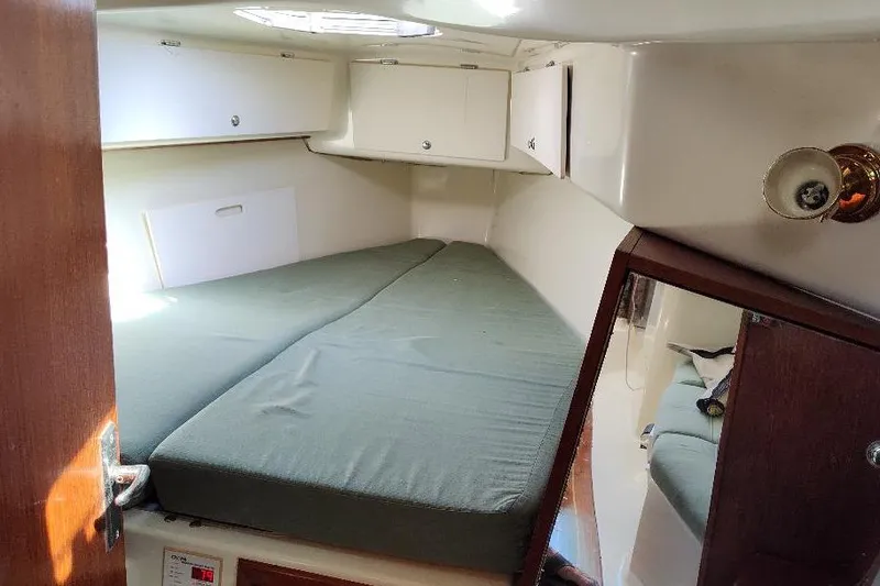 Slide: The Image of 2002 Seaward Eagle 32 RK cabin interior with bed and storage cabinets. - 42