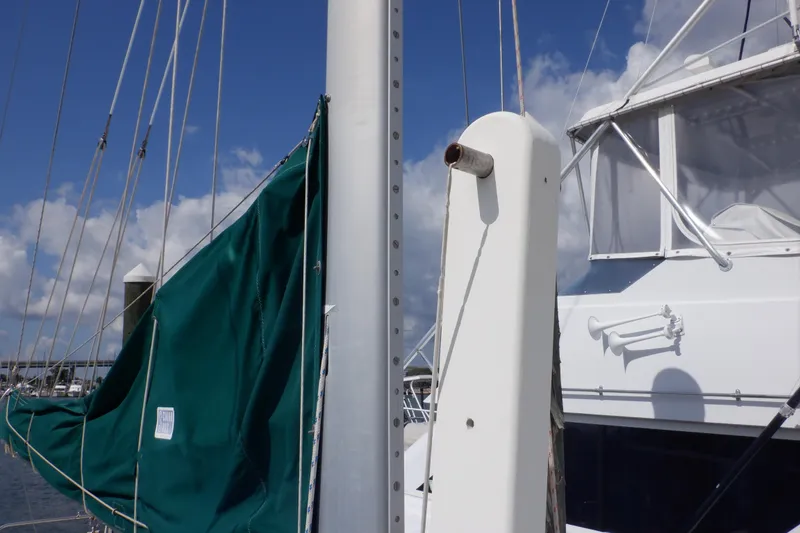 Slide: The Image of 2002 Seaward Eagle 32 RK sailboat mast with green sail cover at marina. - 7