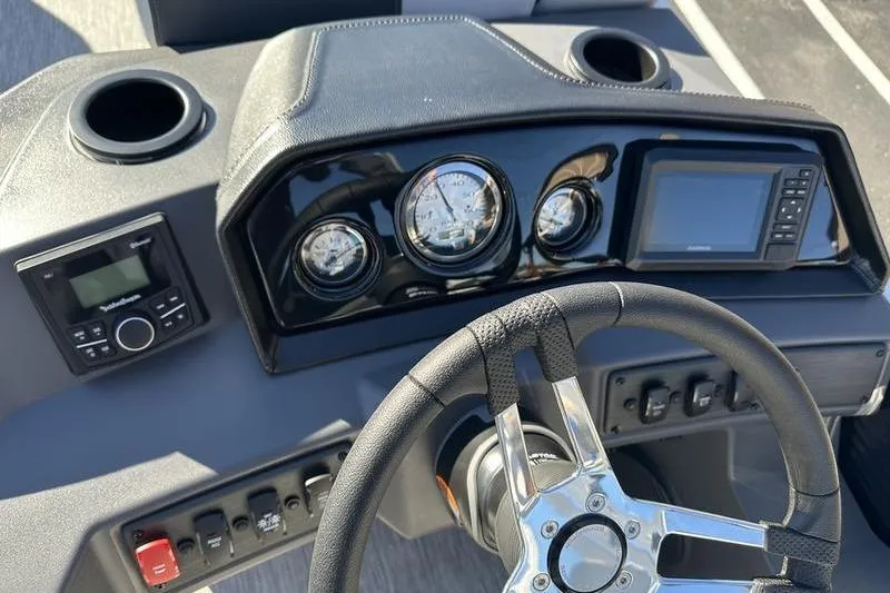Slide: The Image of 2025 Bennington S Fish 22 SF dashboard with steering wheel and control panel. - 13