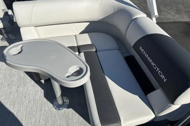 Slide: The Image of 2025 Bennington S Fish 22 SF boat interior with cushioned seating and table. - 15