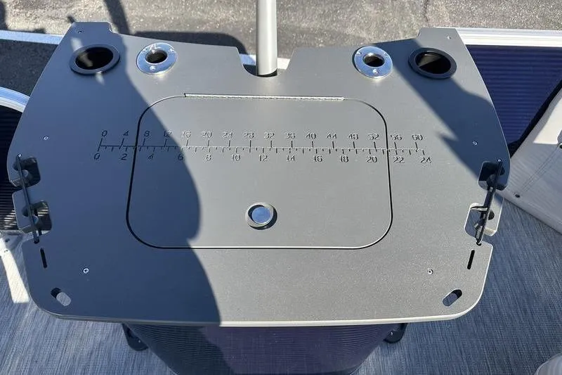 Slide: The Image of 2025 Bennington S Fish 22 SF boat console with cup holders and measurement markings. - 19