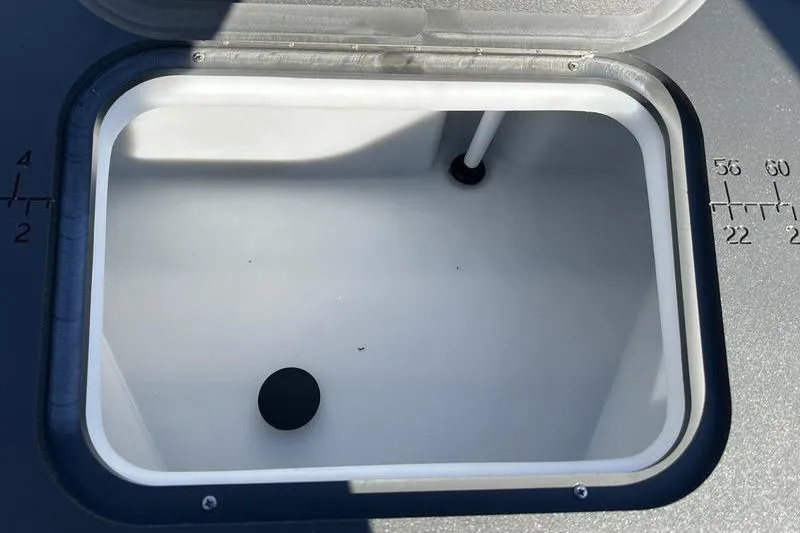 Slide: The Image of Open storage compartment on 2025 Bennington S Fish 22 SF boat, featuring measurement markings. - 20