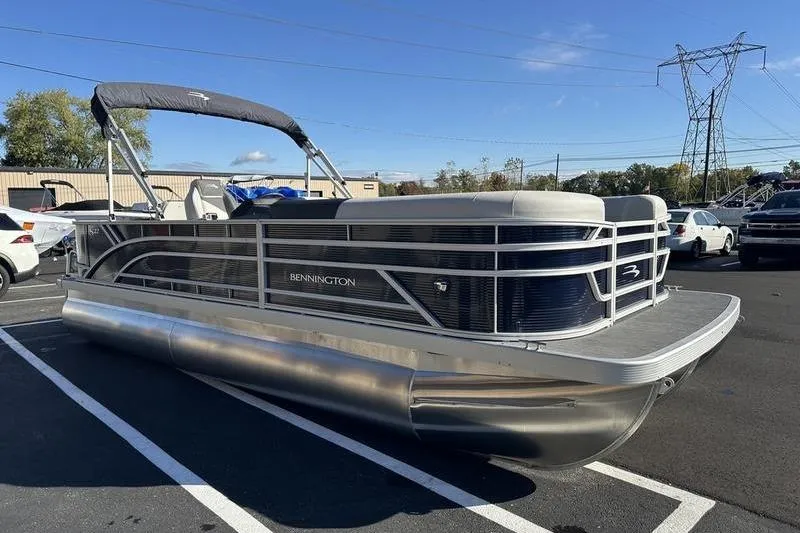 Slide: The Image of 2025 Bennington S Fish 22 SF pontoon boat parked outdoors on a sunny day. - 5