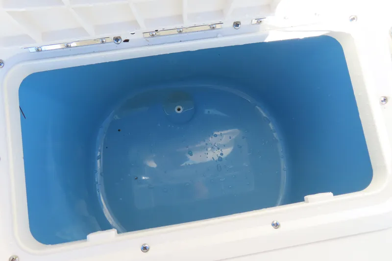Slide: The Image of Open storage compartment in 2017 Carolina Skiff 238 DLV boat, featuring a blue interior. - 15