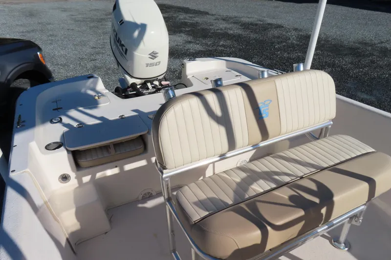 Slide: The Image of 2017 Carolina Skiff 238 DLV boat interior with Suzuki 150 engine and beige seating. - 16
