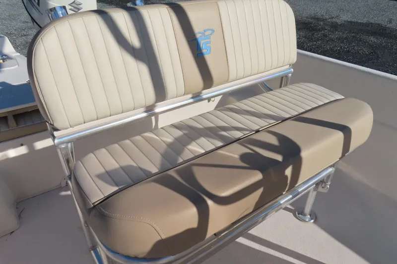 Slide: The Image of 2017 Carolina Skiff 238 DLV boat seat with beige upholstery and metal frame. - 17