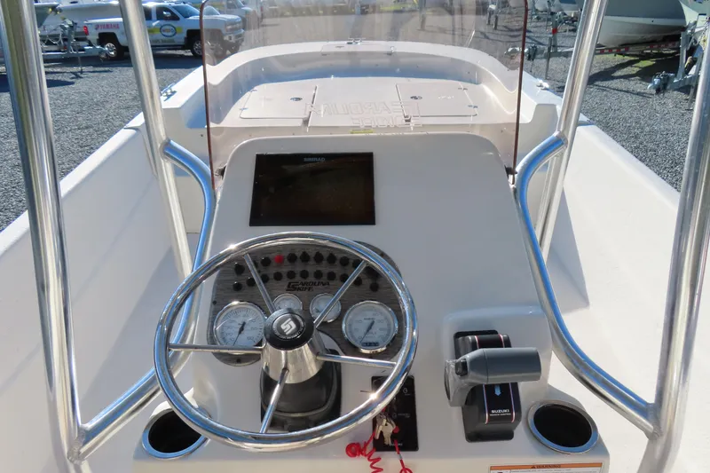 Slide: The Image of 2017 Carolina Skiff 238 DLV boat console with steering wheel and controls. - 18