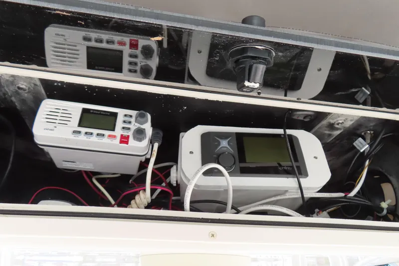 Slide: The Image of 2017 Carolina Skiff 238 DLV electronics panel with VHF radio and navigation equipment. - 19