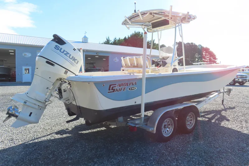 Slide: The Image of 2017 Carolina Skiff 238 DLV boat on trailer with Suzuki outboard motor. - 2