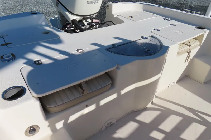 Slide: The Image of 2017 Carolina Skiff 238 DLV boat deck with storage compartments and motor. - 22
