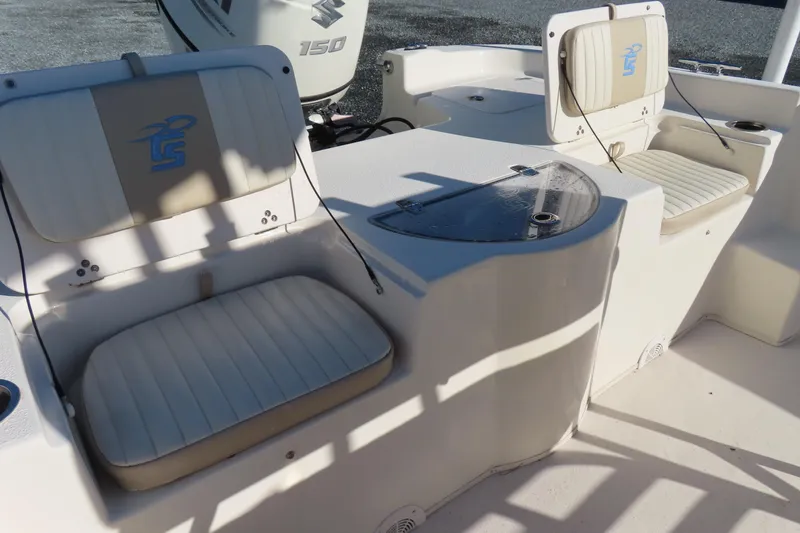 Slide: The Image of 2017 Carolina Skiff 238 DLV boat interior with cushioned seating and Suzuki 150 engine. - 23