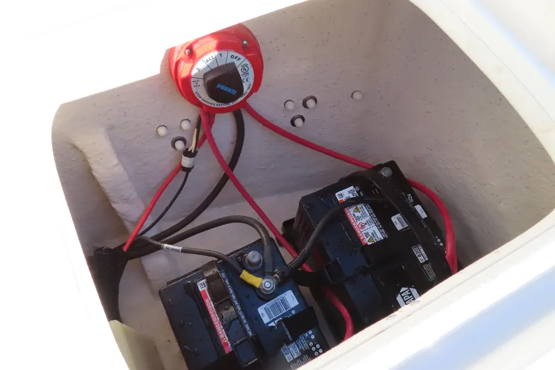 Slide: The Image of Battery compartment of a 2017 Carolina Skiff 238 DLV with wiring and switch. - 25