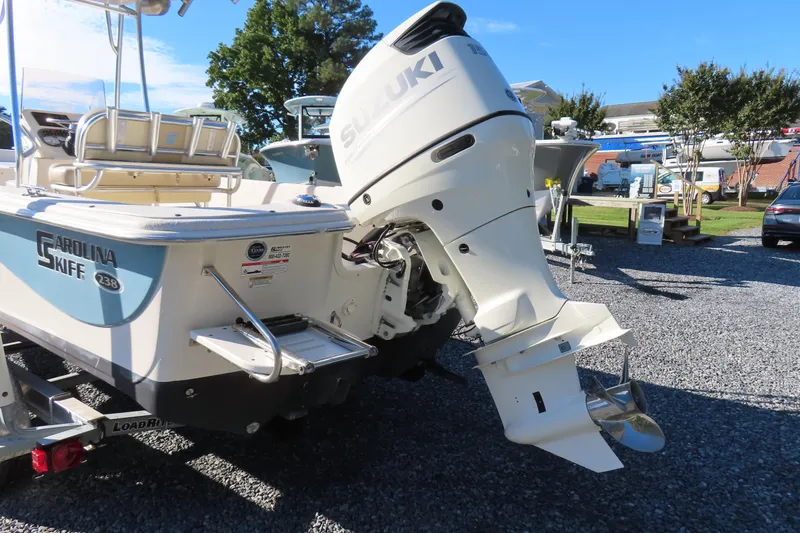 Slide: The Image of 2017 Carolina Skiff 238 DLV boat with Suzuki outboard motor on display. - 3
