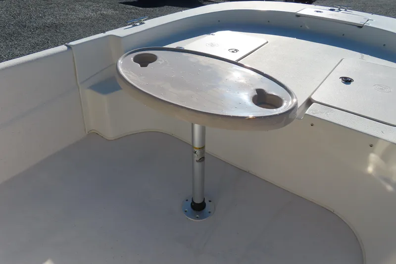 Slide: The Image of 2017 Carolina Skiff 238 DLV boat interior with table and cup holders. - 7