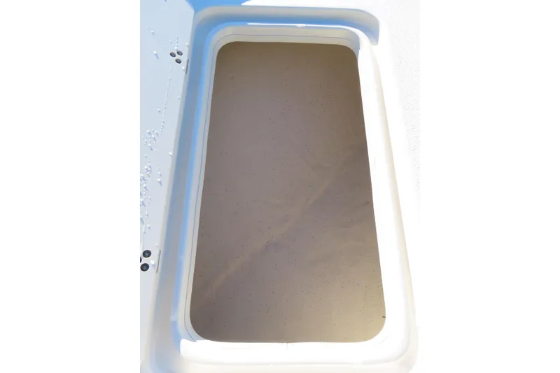 Slide: The Image of Storage compartment of a 2017 Carolina Skiff 238 DLV boat, open and empty. - 9