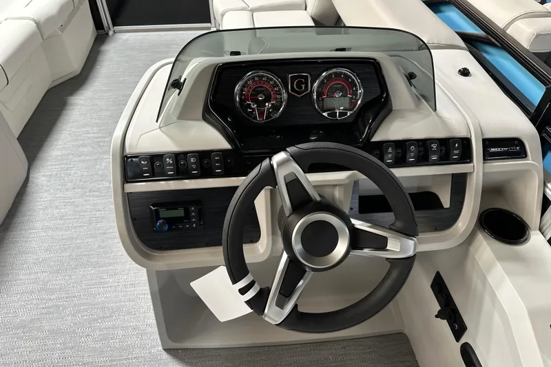 Slide: The Image of 2026 Godfrey SWEETWATER 2286 SFL boat dashboard with steering wheel and control panel. - 11