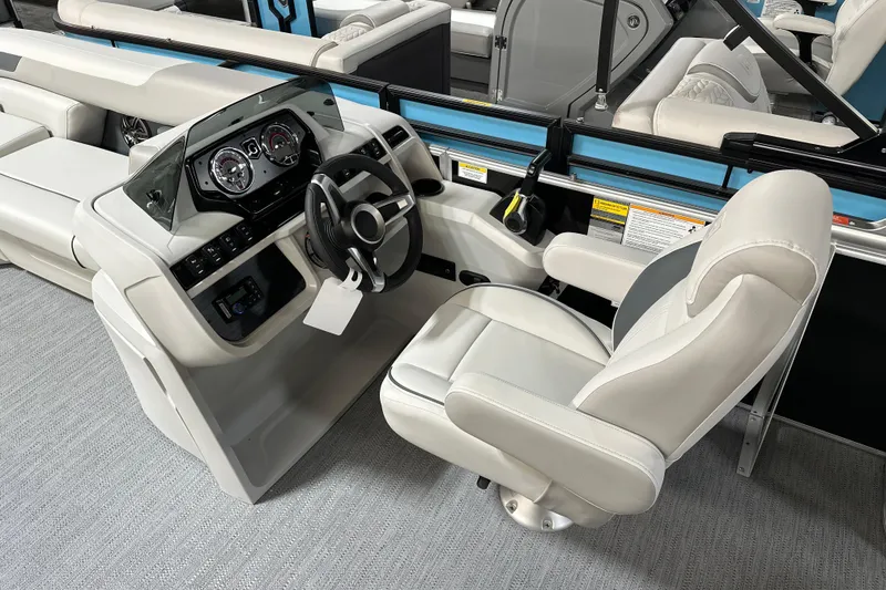 Slide: The Image of 2026 Godfrey SWEETWATER 2286 SFL boat interior with steering console and captain's chair. - 12