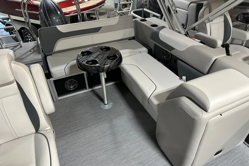 Slide: The Image of 2026 Godfrey SWEETWATER 2286 SFL boat interior with plush seating and cup holders. - 15