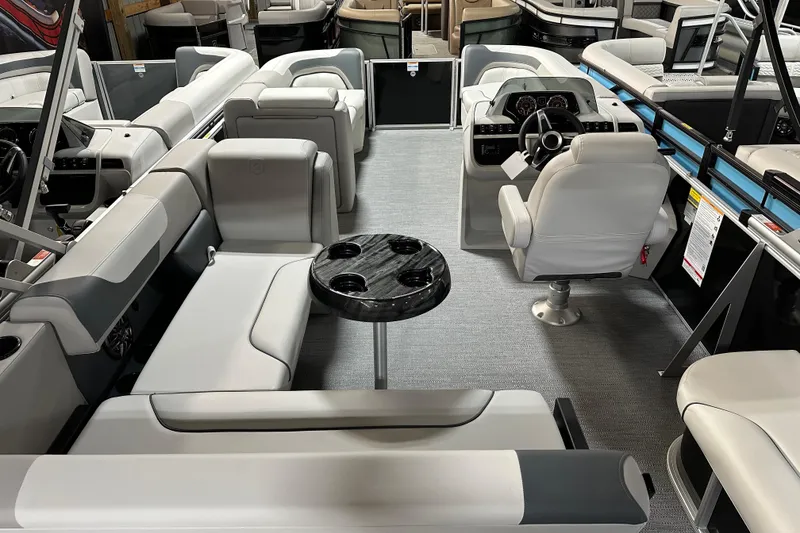 Slide: The Image of 2026 Godfrey SWEETWATER 2286 SFL pontoon boat interior with plush seating and modern helm. - 6