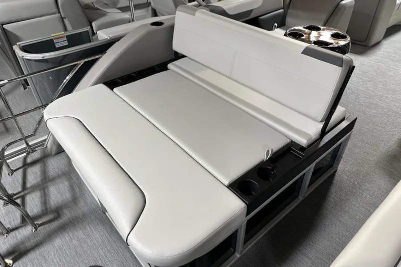 Slide: The Image of 2026 Godfrey SWEETWATER 2286 SFL boat interior with white seating and cup holders. - 9