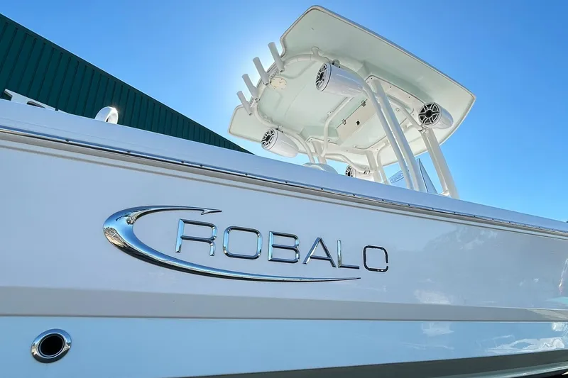 Slide: The Image of 2019 Robalo 226 Cayman boat with sleek design under clear blue sky. - 11