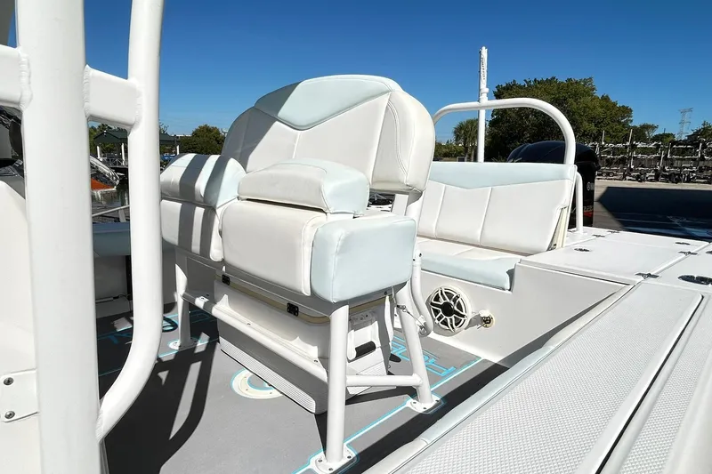 Slide: The Image of 2019 Robalo 226 Cayman boat interior with white seating and console. - 25