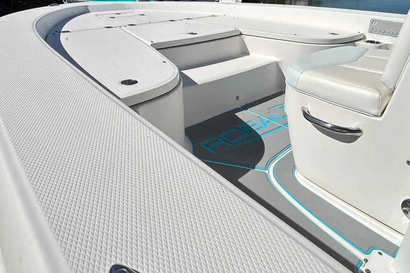 Slide: The Image of 2019 Robalo 226 Cayman boat interior with textured flooring and seating. - 26