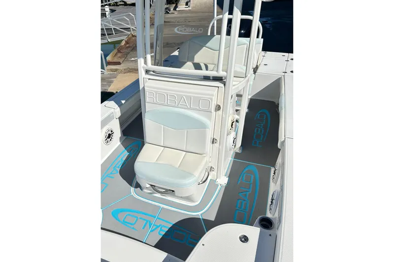 Slide: The Image of 2019 Robalo 226 Cayman boat interior with cushioned seating and branded flooring. - 27
