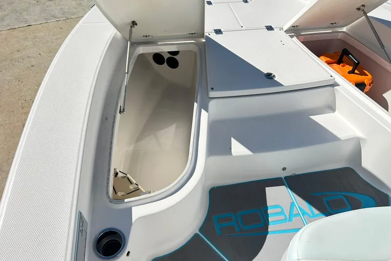 Slide: The Image of 2019 Robalo 226 Cayman boat interior with open storage compartments. - 31