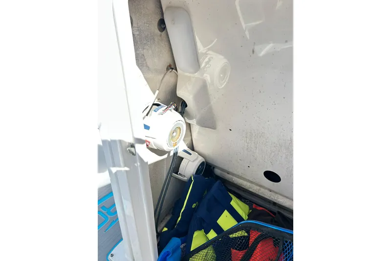 Slide: The Image of Storage compartment of a 2019 Robalo 226 Cayman boat with safety gear. - 36