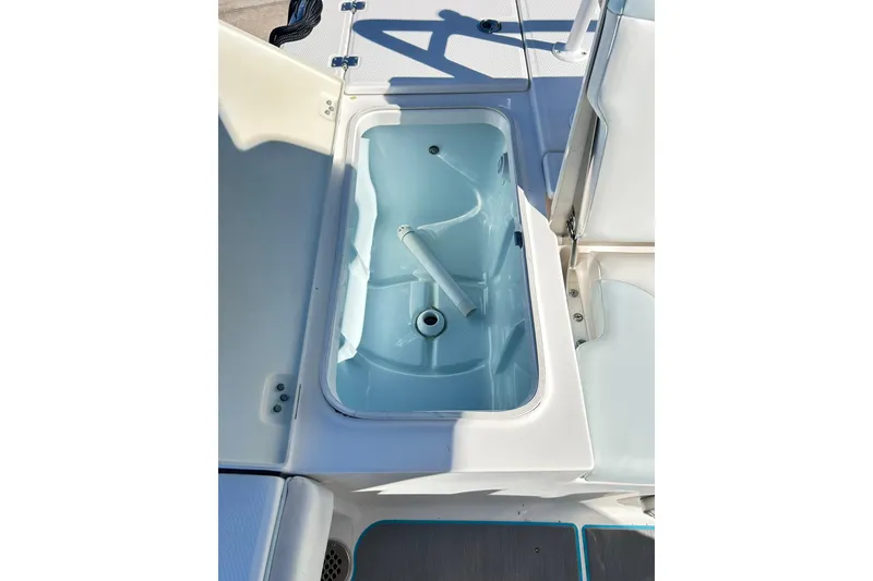 Slide: The Image of 2019 Robalo 226 Cayman boat livewell with open lid, showcasing interior design. - 42