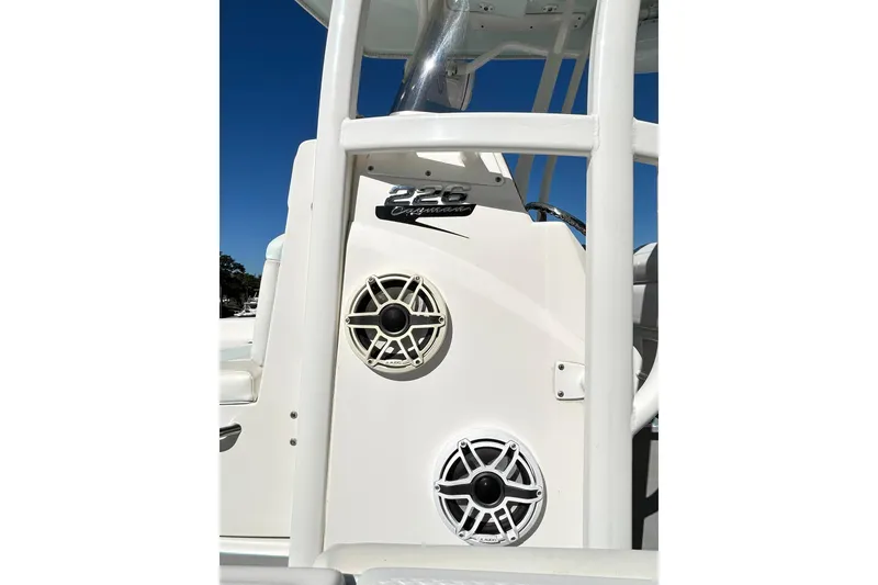 Slide: The Image of 2019 Robalo 226 Cayman boat console with speakers and model branding. - 44