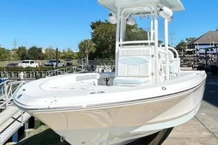 Slide: The Image of 2019 Robalo 226 Cayman boat docked, showcasing sleek design and spacious deck. - 5