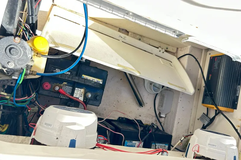 Slide: The Image of 2019 Robalo 226 Cayman boat battery compartment with wiring and components. - 50