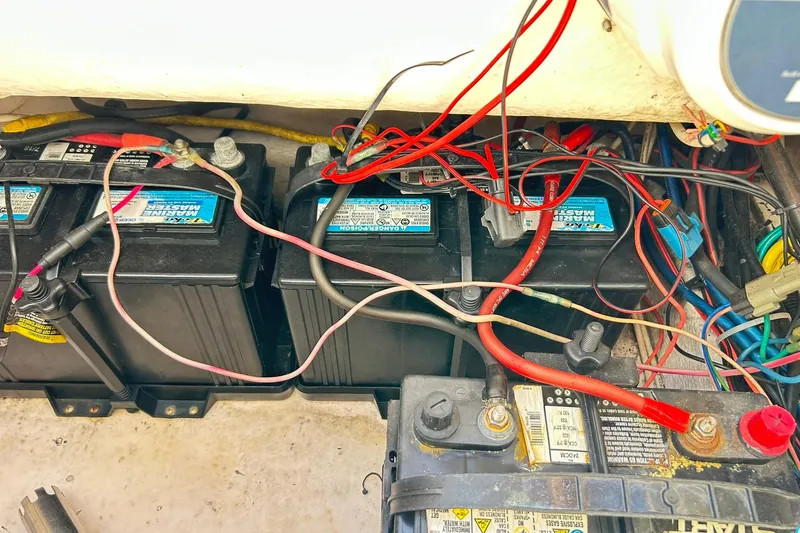 Slide: The Image of 2019 Robalo 226 Cayman boat battery compartment with wiring and connections. - 53