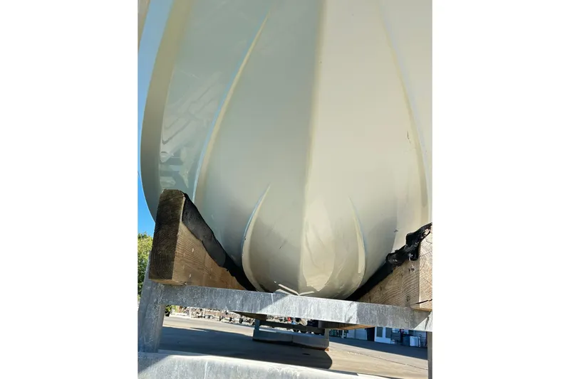Slide: The Image of 2019 Robalo 226 Cayman boat hull on trailer, viewed from below. - 7