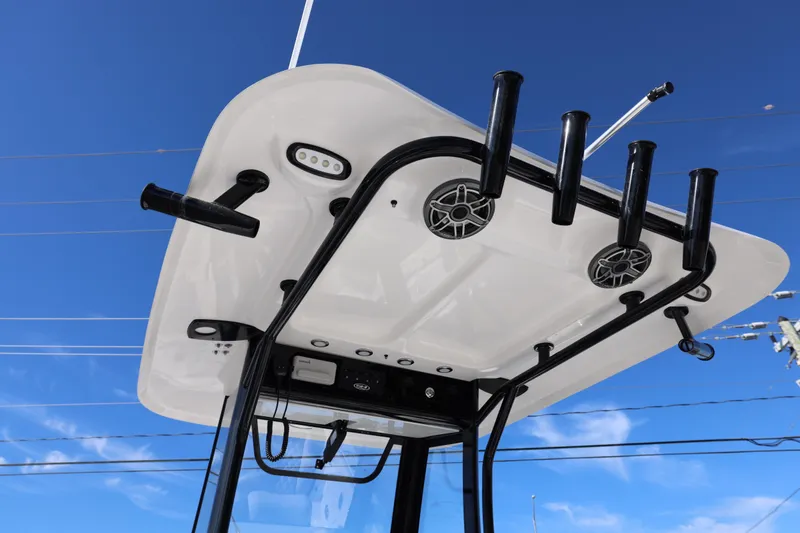 Slide: The Image of 2026 Sea Hunt Ultra 275 SE boat top view with rod holders and speakers against blue sky. - 11