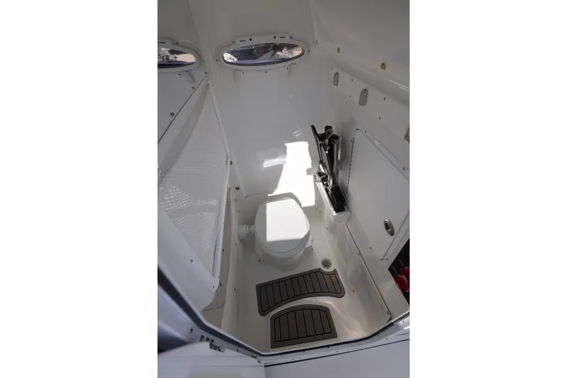 Slide: The Image of Interior of 2026 Sea Hunt Ultra 275 SE boat, featuring a compact marine toilet. - 12