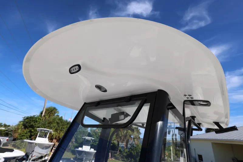 Slide: The Image of 2026 Sea Hunt Ultra 275 SE boat with sleek hardtop against blue sky. - 15