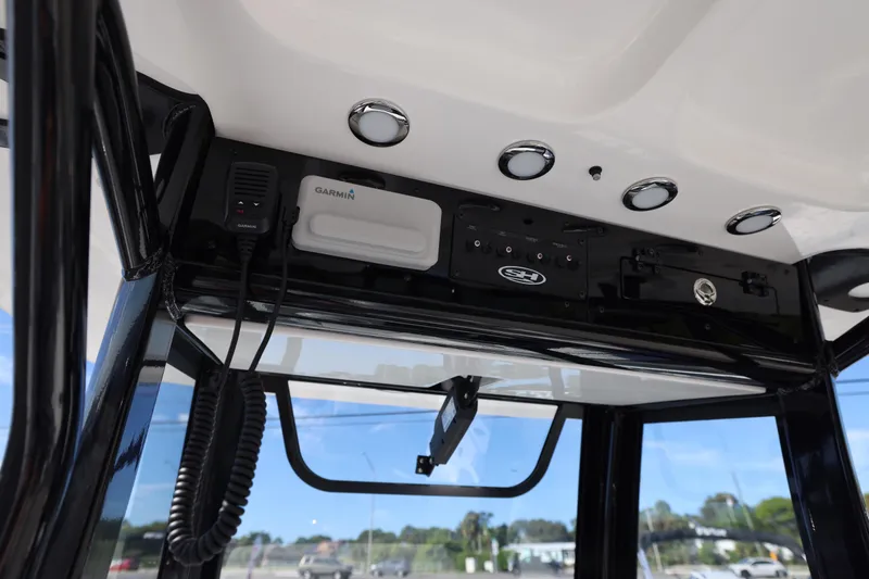Slide: The Image of 2026 Sea Hunt Ultra 275 SE boat console with Garmin electronics and sleek black finish. - 17